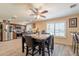 Bright dining area features modern ceiling fan, wood-look floors, and charming window shutters at 6244 W Clouse Dr, Phoenix, AZ 85033