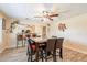 Open dining area with wood-look flooring, modern decor, and bar seating in the background at 6244 W Clouse Dr, Phoenix, AZ 85033