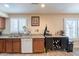 Kitchen area with stainless steel sink, granite countertops, and a wine storage unit at 6244 W Clouse Dr, Phoenix, AZ 85033