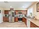 Spacious kitchen featuring stainless steel appliances, granite countertops, and wood-look flooring at 6244 W Clouse Dr, Phoenix, AZ 85033