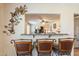 The kitchen bar looks out into the living room area and includes decor to make it inviting at 6244 W Clouse Dr, Phoenix, AZ 85033