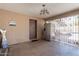 View of covered patio with fridge, block walls, and security gate leading to a pool at 6244 W Clouse Dr, Phoenix, AZ 85033