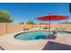 An inground pool is surrounded by patio, a block wall, and an outdoor grilling station with sink and counterspace at 6244 W Clouse Dr, Phoenix, AZ 85033