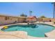 Backyard pool with beach entry, patio, lounge seating, and a shed at 6244 W Clouse Dr, Phoenix, AZ 85033