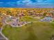 Expansive aerial view showcasing the lush park and community amenities under a vibrant, partly cloudy sky at 6556 N 43Rd Ave, Glendale, AZ 85301