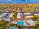 Aerial view of a well maintained community, tree-lined street, and pool in the foreground at 6556 N 43Rd Ave, Glendale, AZ 85301