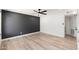 Spacious bedroom with wood-look flooring and a contemporary accent wall offers a serene retreat at 6556 N 43Rd Ave, Glendale, AZ 85301