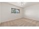 Bright bedroom with neutral carpet and ample natural light from the window at 6556 N 43Rd Ave, Glendale, AZ 85301