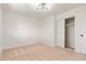 Neutral carpeted bedroom with sliding closet doors and a modern light fixture at 6556 N 43Rd Ave, Glendale, AZ 85301