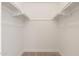Walk in closet with built in shelving and neutral carpeting at 6556 N 43Rd Ave, Glendale, AZ 85301
