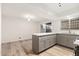 Modern kitchen featuring a bar area, stainless steel appliances, and a sliding glass door at 6556 N 43Rd Ave, Glendale, AZ 85301