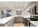 Modern kitchen featuring stainless steel appliances, a long breakfast bar, and updated finishes at 6556 N 43Rd Ave, Glendale, AZ 85301