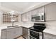 Modern kitchen featuring stainless steel appliances, quartz countertops, and grey cabinetry at 6556 N 43Rd Ave, Glendale, AZ 85301