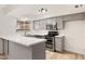 Updated kitchen featuring stainless steel appliances, a breakfast bar, and ample counter space at 6556 N 43Rd Ave, Glendale, AZ 85301