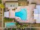 Aerial view of the community pool with shuffleboard courts, a sunbathing area, and well-kept landscaping at 6556 N 43Rd Ave, Glendale, AZ 85301