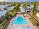 Aerial view of a community pool with multiple residents swimming in a uniquely shaped sparkling blue pool at 6556 N 43Rd Ave, Glendale, AZ 85301