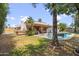 Landscaped backyard featuring pool, lounge chairs, and covered patio at 6611 E Voltaire Ave, Scottsdale, AZ 85254