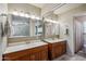 Bright bathroom featuring double sink vanity, ample lighting and large mirrors at 6611 E Voltaire Ave, Scottsdale, AZ 85254