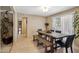 Bright dining area with wood table and chairs, tile floors, and access to outdoor area at 6611 E Voltaire Ave, Scottsdale, AZ 85254