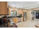 Spacious kitchen with stainless steel refrigerator, wood cabinets, and granite countertops at 6611 E Voltaire Ave, Scottsdale, AZ 85254