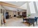 Inviting open-concept living area featuring a cozy fireplace, unique ceiling beams, and tile floors at 6611 E Voltaire Ave, Scottsdale, AZ 85254