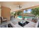 Covered outdoor patio features dining and lounge seating with pool views at 6611 E Voltaire Ave, Scottsdale, AZ 85254