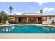 Inviting backyard featuring a sparkling pool, lounge chairs, and a covered patio at 6611 E Voltaire Ave, Scottsdale, AZ 85254