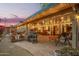 Backyard featuring a covered patio with cafe lighting, a grill, outdoor furniture and landscaping at 7423 E Cambridge Ave, Scottsdale, AZ 85257