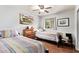 Shared bedroom with ceiling fan, light-toned walls, hardwood floors, and two beds at 7423 E Cambridge Ave, Scottsdale, AZ 85257