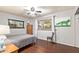 Cozy bedroom features wood floors, a ceiling fan, and light gray walls at 7423 E Cambridge Ave, Scottsdale, AZ 85257
