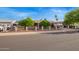 Charming single story home featuring an enclosed front yard, mature trees, and covered carport at 7423 E Cambridge Ave, Scottsdale, AZ 85257