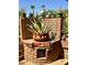 Unique brick garden display featuring a variety of potted plants and a charming gnome statue, adding character at 7423 E Cambridge Ave, Scottsdale, AZ 85257