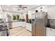 Bright kitchen with stainless steel appliances, black countertops, and modern backsplash at 7423 E Cambridge Ave, Scottsdale, AZ 85257