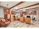 Inviting living room with wood beam ceiling, custom storage, and beautiful wood laminate flooring at 7423 E Cambridge Ave, Scottsdale, AZ 85257