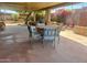 Relaxing covered patio with outdoor dining set, grill, and colorful desert landscaping at 7423 E Cambridge Ave, Scottsdale, AZ 85257