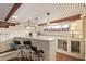 Home wet bar featuring stylish barstool seating, brick counters, and under cabinet storage space at 7423 E Cambridge Ave, Scottsdale, AZ 85257