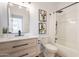 A bathroom featuring a modern vanity, a framed mirror, and a bathtub-shower combo with stylish fixtures at 7516 W Mary Jane Ln, Peoria, AZ 85382