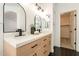 Elegant bathroom with double sink vanity, quartz counters, modern fixtures, and access to walk-in closet at 7516 W Mary Jane Ln, Peoria, AZ 85382