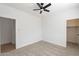 Comfortable bedroom with ceiling fan and two open doorways at 7516 W Mary Jane Ln, Peoria, AZ 85382