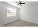 Bedroom with ceiling fan, window with blinds for a pleasant ambiance, and outlets for convenience at 7516 W Mary Jane Ln, Peoria, AZ 85382