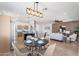 Open floor plan shows view of kitchen, dining, and living space with modern lighting at 7516 W Mary Jane Ln, Peoria, AZ 85382