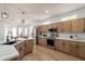 Spacious kitchen with stainless steel appliances, wood cabinets and quartz countertops, perfect for culinary enthusiasts at 7516 W Mary Jane Ln, Peoria, AZ 85382