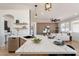 Beautiful view of open floor plan showcases quartz counters, modern sink and faucets with view to living space at 7516 W Mary Jane Ln, Peoria, AZ 85382