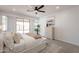 Bright main bedroom features a ceiling fan, natural light, and stylish decor for a tranquil ambiance at 7516 W Mary Jane Ln, Peoria, AZ 85382