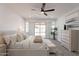 Well-lit main bedroom boasts plush carpeting, a ceiling fan, and sliding glass doors leading to the backyard at 7516 W Mary Jane Ln, Peoria, AZ 85382