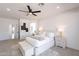 Bright main bedroom showcasing a ceiling fan, neutral tones, and an ensuite bathroom at 7516 W Mary Jane Ln, Peoria, AZ 85382