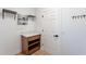 Mudroom with hanging racks, shelving, and a counter for storage, offering a seamless transition from outdoors at 7516 W Mary Jane Ln, Peoria, AZ 85382