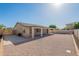 A single story home features a covered patio and low-maintenance desert landscaping in the backyard at 7516 W Mary Jane Ln, Peoria, AZ 85382