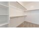 Spacious walk-in closet with shelving and metal hanging racks for optimal storage solutions at 7516 W Mary Jane Ln, Peoria, AZ 85382