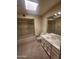 The bathroom has a skylight, a vanity with a sink, and a shower-tub combo with glass doors at 7646 E Miami Rd, Scottsdale, AZ 85258